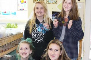 Clockwise from top left: Darian Smith, Emma Fuller, Breanna Tryon, and Shaelynn Flagler show off their glasswork.